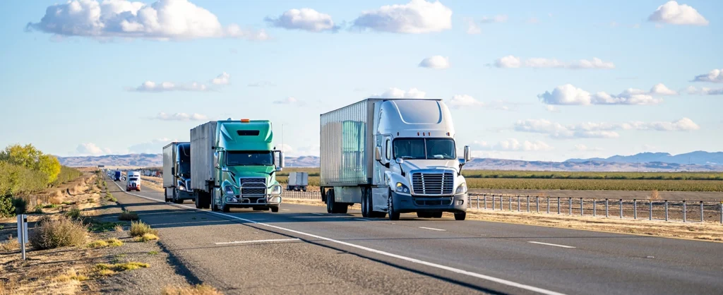 two semi trucks on freeway