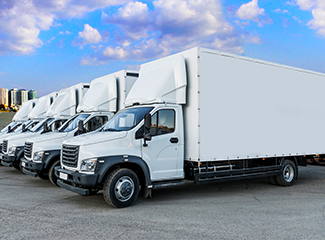 four white Box trucks in a line