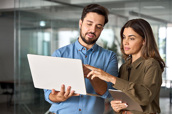 Two associates reviewing a shipping order online