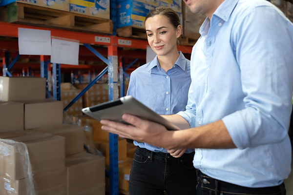 two people discussing logistics in a warehouse